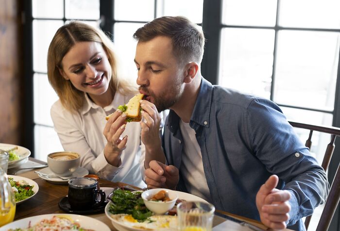 Two employees sharing a meal and insider tricks that make their jobs so much easier in a bright dining area.
