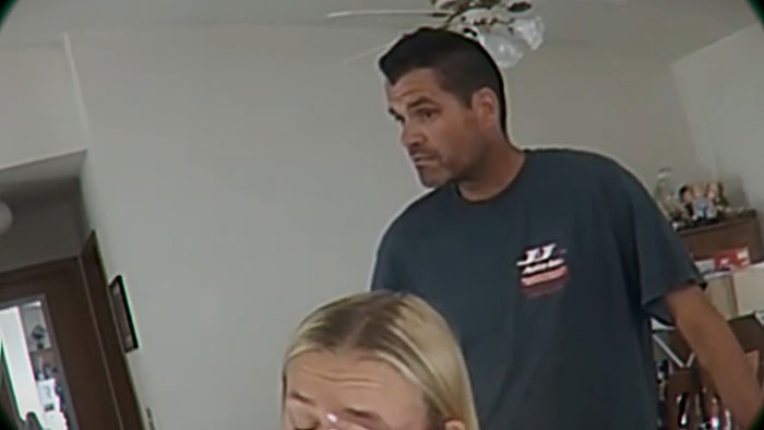 Man showing devastated reaction in a home setting after discovering wife secretly bullied their daughter.