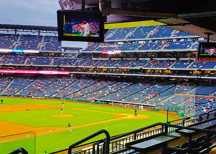 View of an MLB baseball game in a stadium, capturing the field and fans discussing a viral Phillies Karen confrontation.