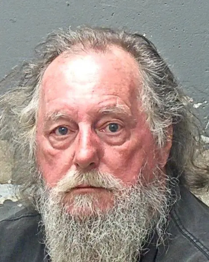 Mugshot of an older man with a long gray beard related to butt dial arrest in flight attendant mysterious disappearance case.