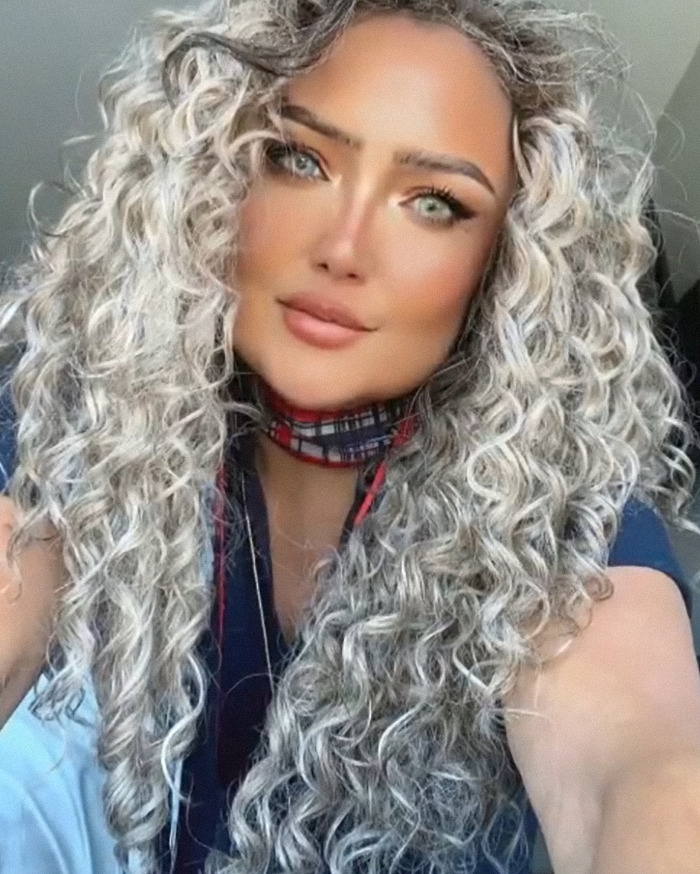 Young woman with long curly hair and plaid neck scarf linked to flight attendant&rsquo;s mysterious disappearance arrest.