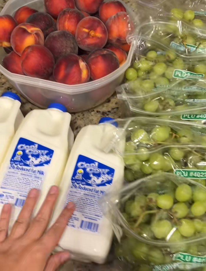 Assorted fresh fruits and milk from a food bank, illustrating the concept of USA richest poor people and food assistance.