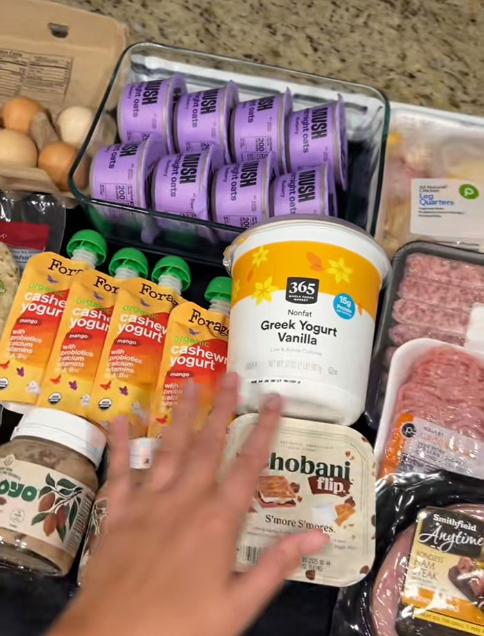 Various food items including yogurt, oats, and meat displayed on a counter from a food bank visit in the USA.