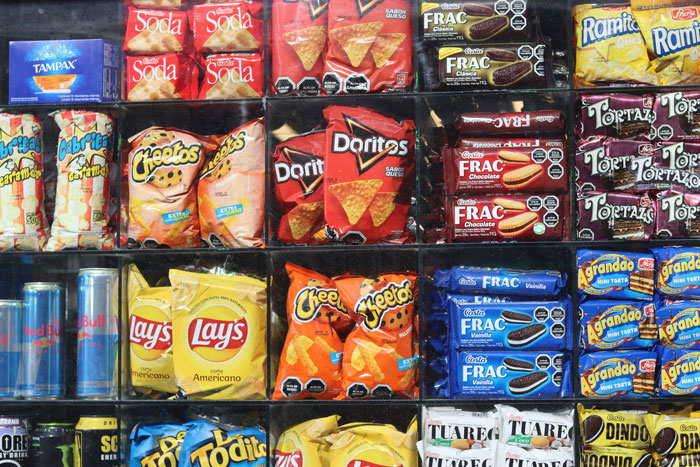 Supermarket shelves filled with snack products highlighting viral food engineer exposing shopper tricks.