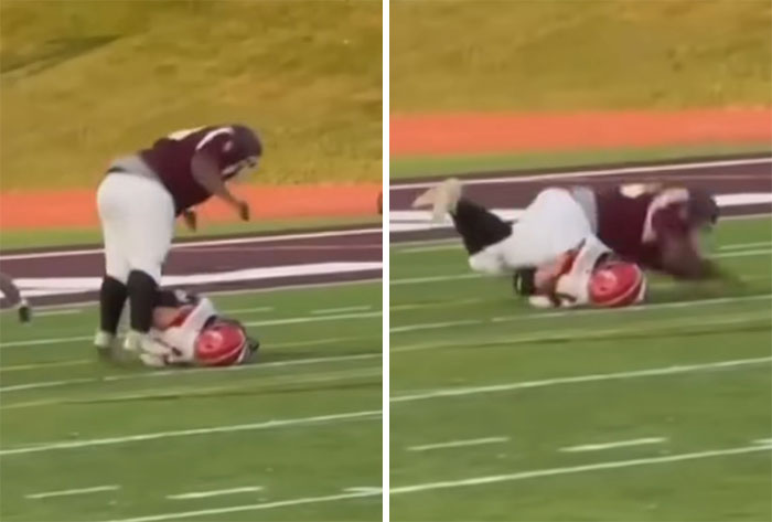 Football player tackling rival on field during a game, highlighting school action after spinal injury incident.