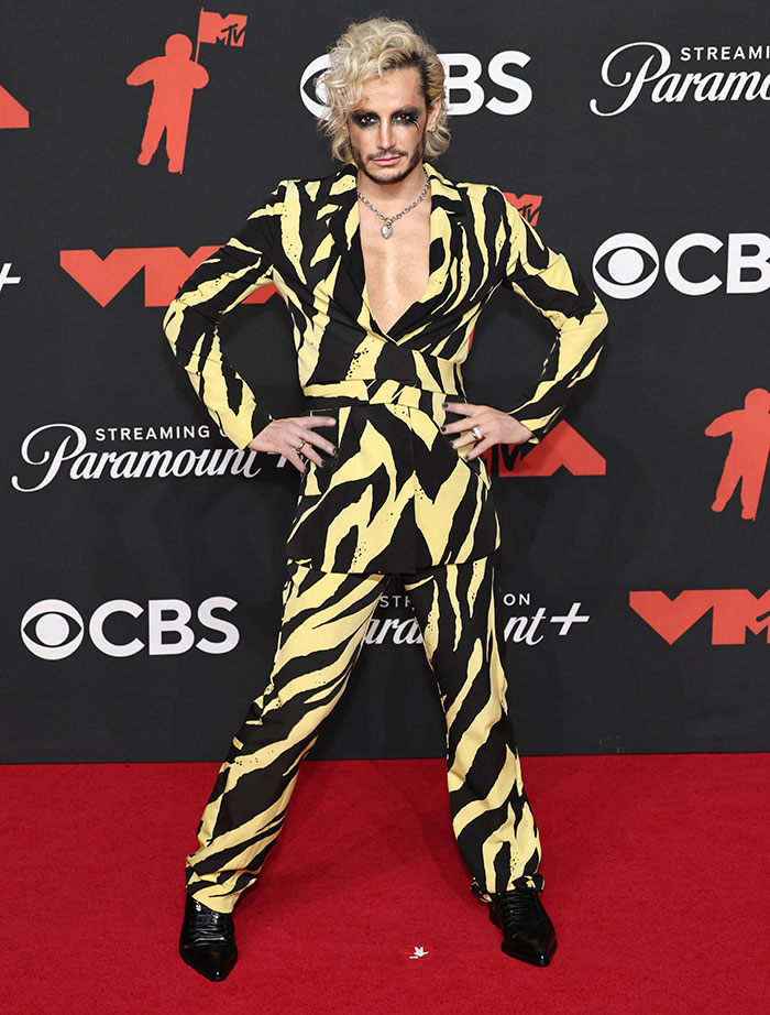Person posing on the red carpet in a bold yellow and black patterned suit at the 2025 Video Music Awards worst dressed stars.