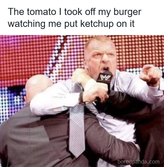 Man in WWE suit angrily restrained by security, meme caption about men humor and coping with ketchup on burger.