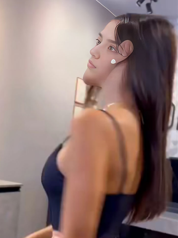 Young influencer posing indoors with long dark hair and a black top, highlighting influencer behavior called out online.