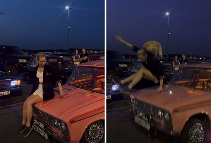 Young woman provocatively sitting and jumping on a vintage pink car at night, surrounded by parked vehicles and onlookers.