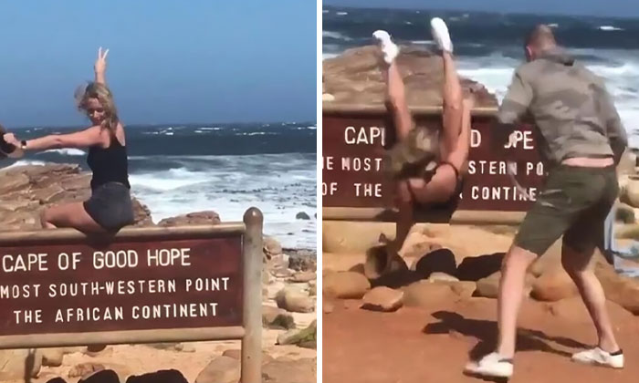 Influencer posing dangerously on Cape of Good Hope sign, then falling off, demonstrating ridiculous influencer behavior called out online.