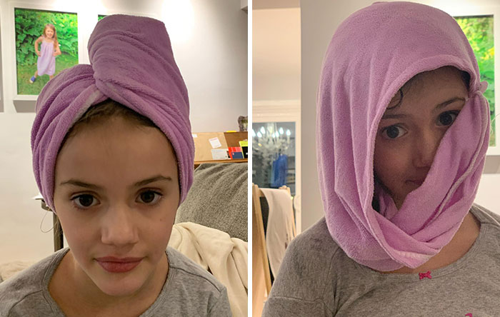 Young girl wearing a purple towel wrapped differently on her head showing funny differences between moms and dads.
