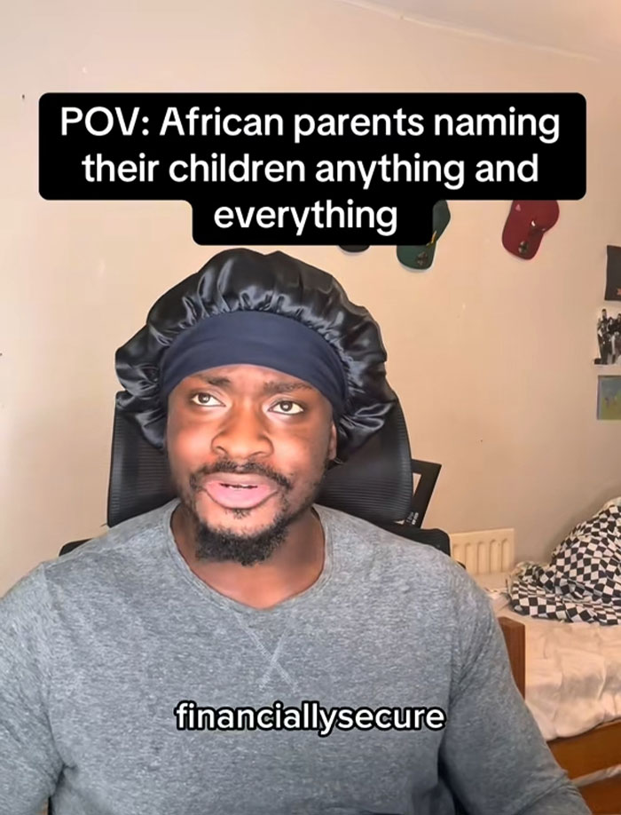 Man wearing a black bonnet and gray shirt discussing African names people can’t believe are real in a casual room setting. Man wearing a black bonnet and gray shirt discussing African names people can’t believe are real in a casual room setting.