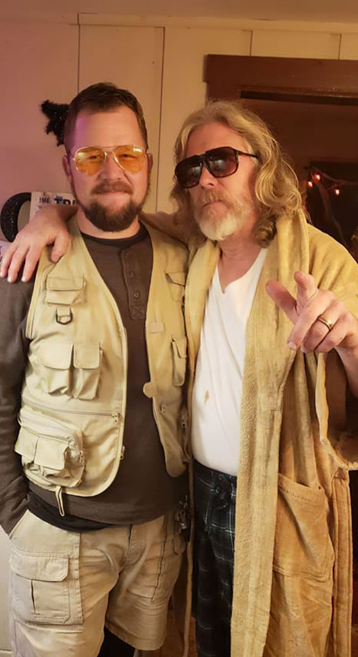 Two men wearing sunglasses pose together indoors, showcasing funny parents in a lighthearted, casual setting.