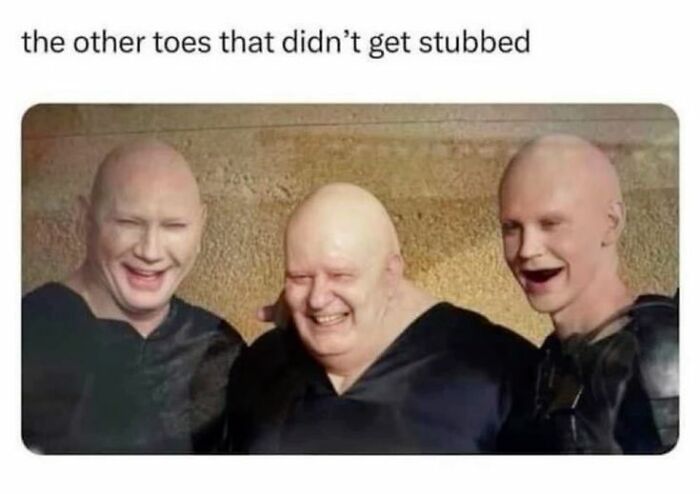 Three bald men with exaggerated facial expressions laughing together in a funny super culture meme about stubbed toes.