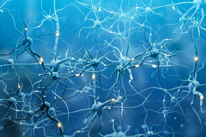 Neurons firing in a blue network, illustrating scientific concepts related to trusting your gut feeling and precognition.