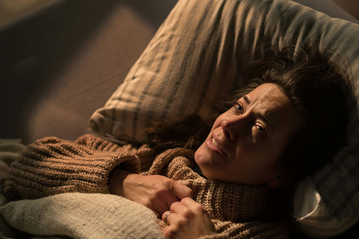Woman lying in bed looking upset and thoughtful, reflecting emotions connected to remarry and cheater ex feelings. Woman lying in bed looking upset and thoughtful, reflecting emotions connected to remarry and cheater ex feelings.