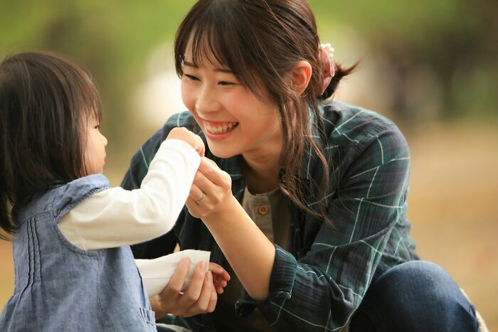 Smiling mother and child outdoors sharing a moment, illustrating effective parenting hacks that save sanity and strengthen bonds.
