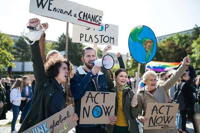 Young activists at a rally holding protest signs urging action, representing the next big thing that totally flopped movement.