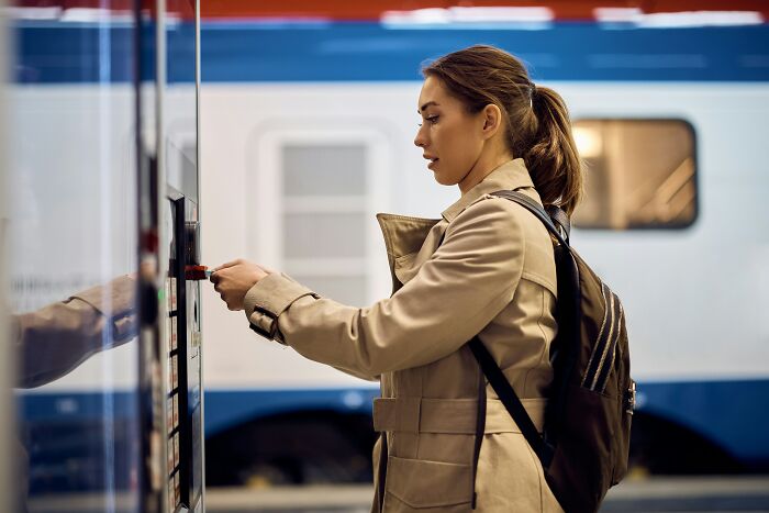 Employee using a ticket machine at a train station applying insider tricks to make her job easier and more efficient.