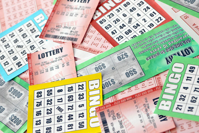 Lottery and bingo tickets scattered on a table, illustrating chance and winning related to girlfriend wants quit job won lottery.