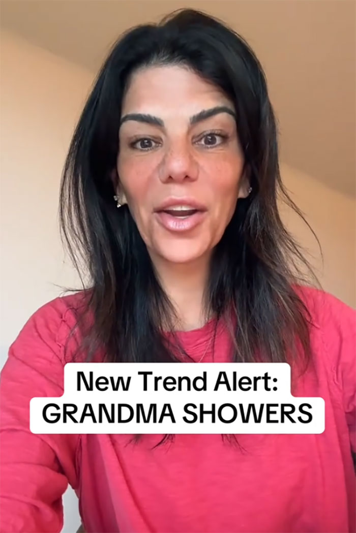 Woman in a red shirt discussing the new trend of grandmas having baby showers celebrating their new status