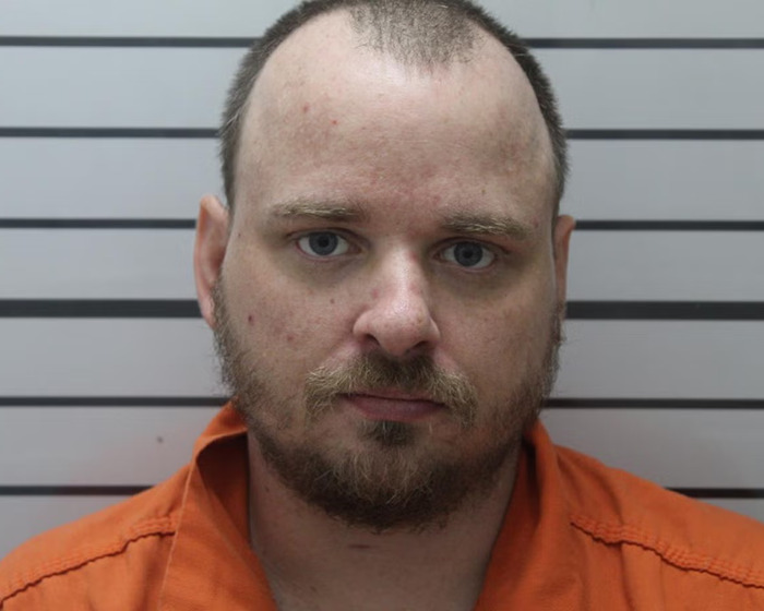 Mugshot of a man in an orange prison jumpsuit related to the case of an 11-year-old girl allegedly giving birth to stepfather's baby.
