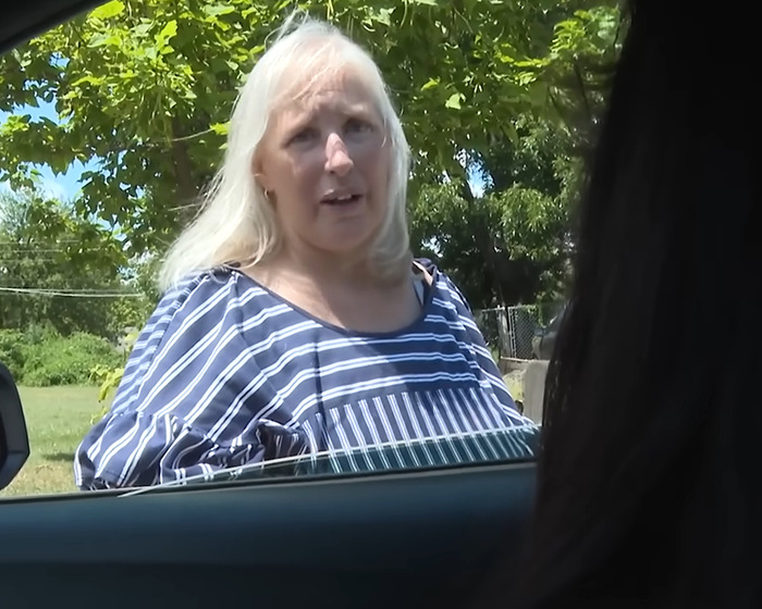 Woman with long blonde hair wearing a striped shirt outdoors, related to grandma arrested after 11-year-old girl's case.