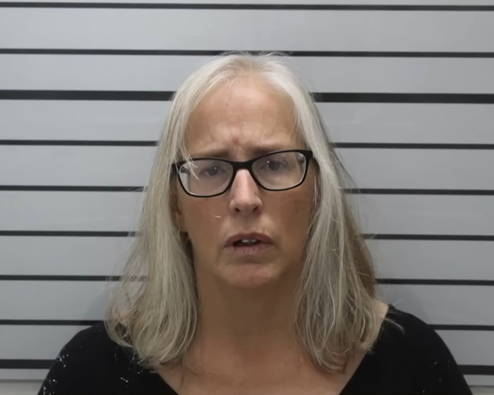 Grandma with gray hair and glasses in mugshot after arrest related to alleged stepfather baby case involving 11-year-old girl