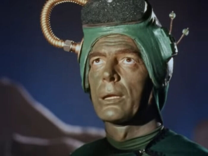 Actor wearing a retro sci-fi helmet in a classic worst-best movie scene enjoyed by audiences through history.