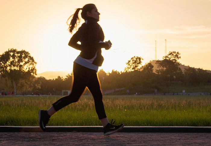 Woman running outdoors at sunset, symbolizing people thankful they listened to their instincts in difficult situations.