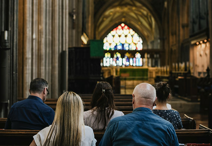 People sitting inside a church, reflecting quietly, illustrating moments when listening to instincts proved vital.