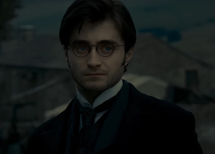 Man resembling Harry Potter wearing round glasses and dark clothing in a moody, dimly lit outdoor setting from a fan-made trailer.
