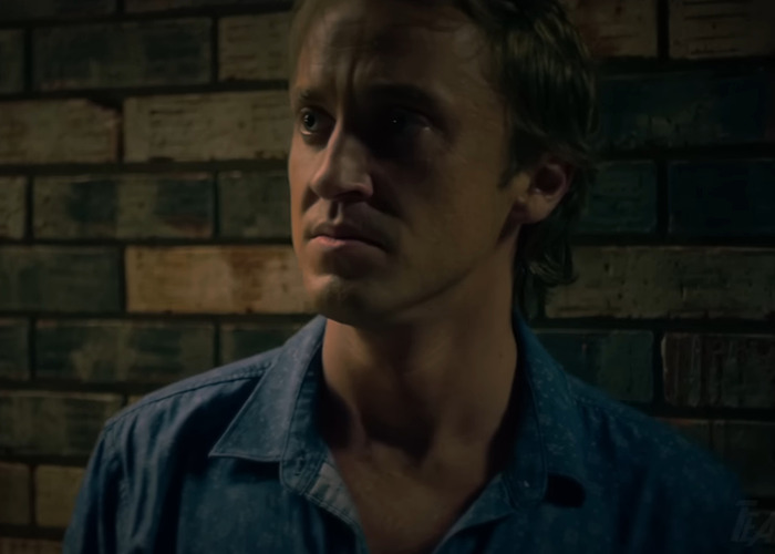 Young man in a dimly lit setting, representing Harry Potter and the Cursed Child fan-made trailer scene.