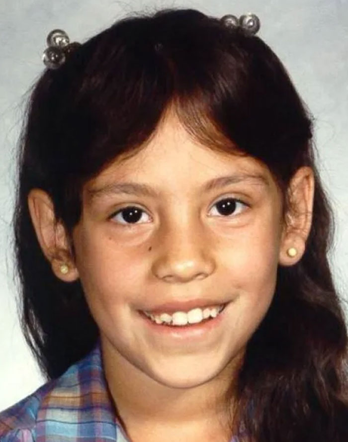 Young girl smiling in a portrait photo representing chilling messages people left before going missing cases.