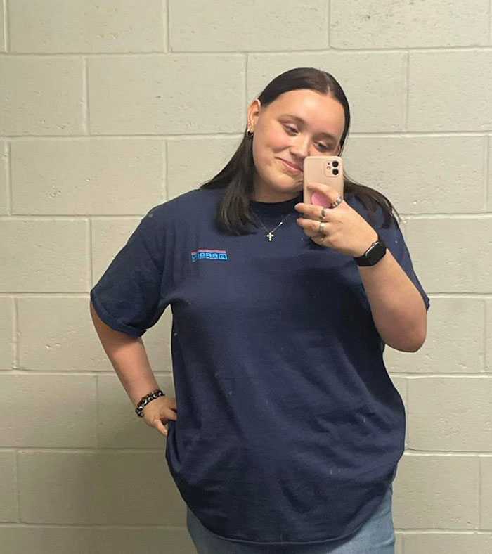 Young woman taking a mirror selfie wearing a navy shirt, representing chilling messages people left before going missing.