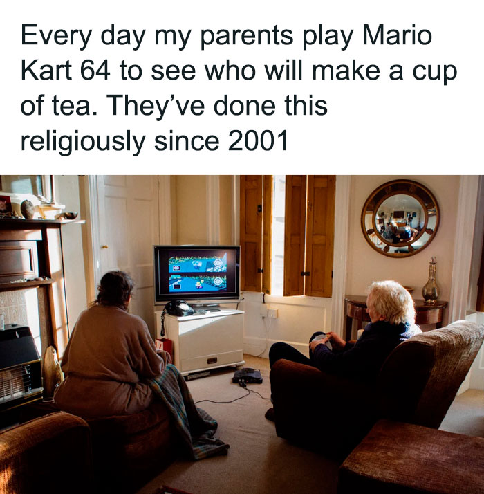 Elderly couple playing Mario Kart 64 at home, sharing a heartwarming moment from inspiring stories to cleanse negativity.