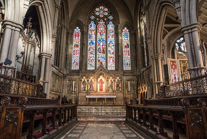 Gothic church interior with stained glass windows and wooden pews, illustrating historic bruh moments in history.