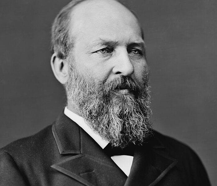 Black and white portrait of a bearded man in formal attire representing iconic bruh moments in history.