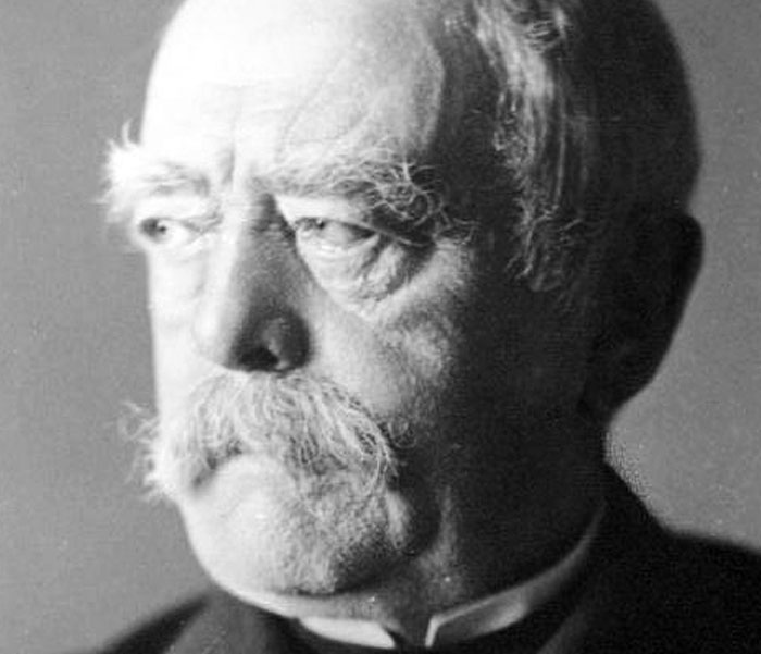 Black and white portrait of an elderly man with a mustache, reflecting on weird and iconic bruh moments in history.