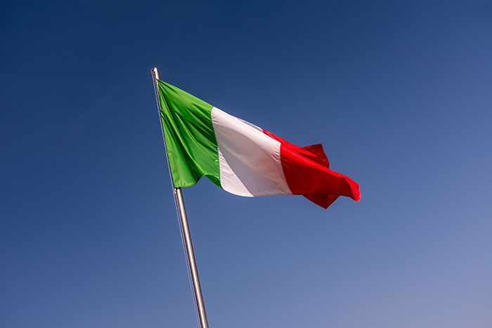 Italian flag waving against clear blue sky representing a weird and iconic bruh moment in history.