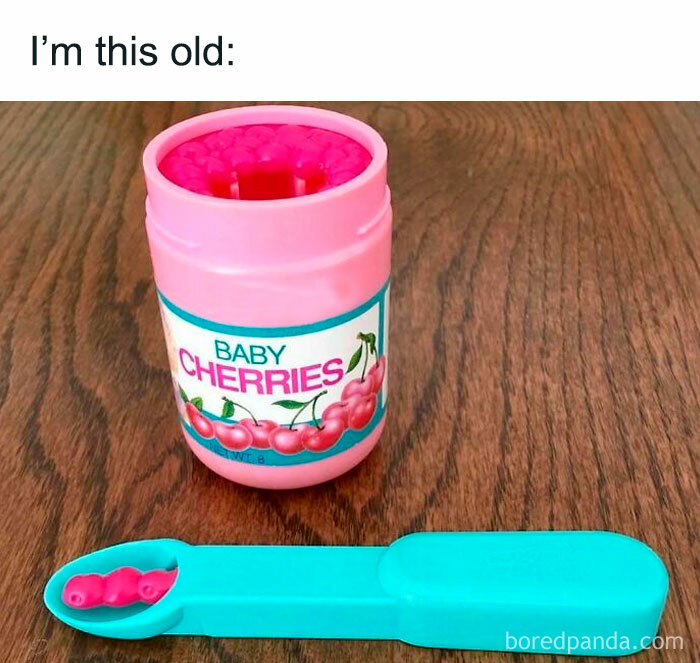 Baby cherries candy container with green measuring spoon on wood table, nostalgic 90s millennial therapy meme.