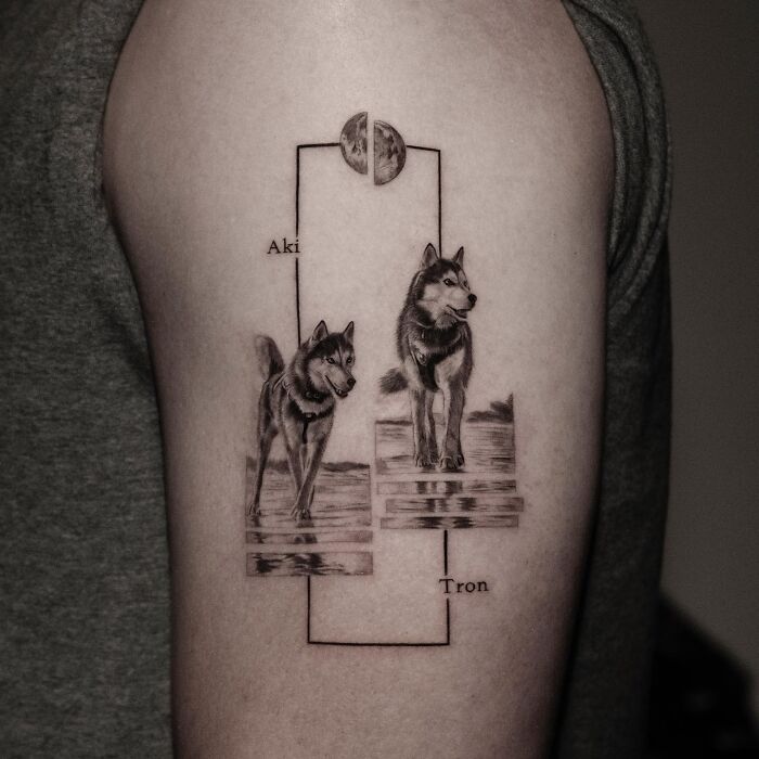 Realistic black and gray emotional pet tattoos of two dogs on upper arm by Korean tattoo artist.