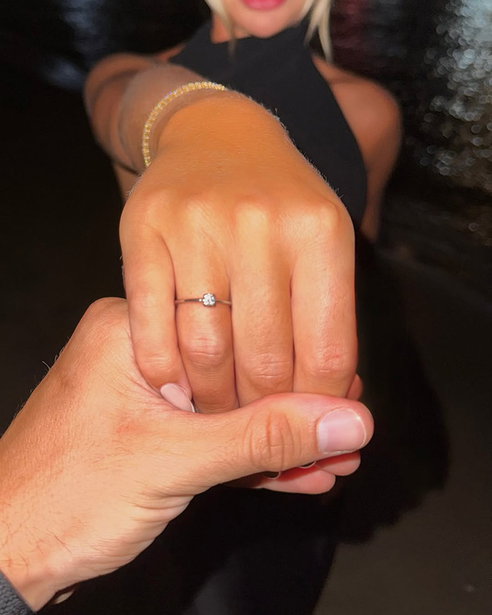 Woman showing engagement ring while holding hand, highlighting viral engagement post for all the wrong reasons. Woman showing engagement ring while holding hand, highlighting viral engagement post for all the wrong reasons.