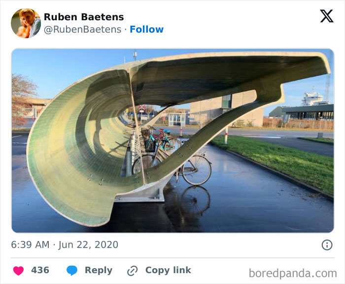 Modern Danish prison cell design with a unique curved exterior structure and bicycles parked nearby outdoors.