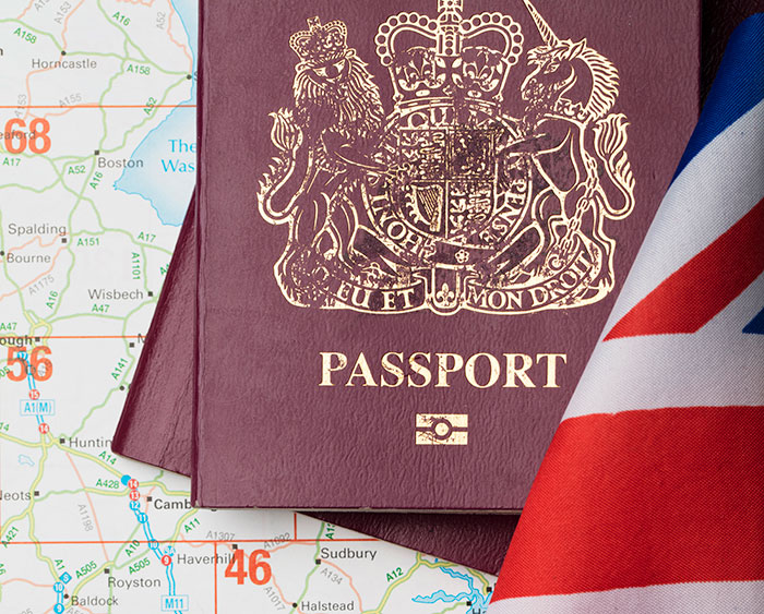 Close-up of a UK passport with a British flag and map, representing travel and fascinating knowledge facts.