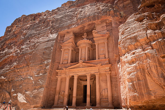 Ancient rock-cut architecture at Petra, showcasing stunning details in a desert landscape for fascinating knowledge.