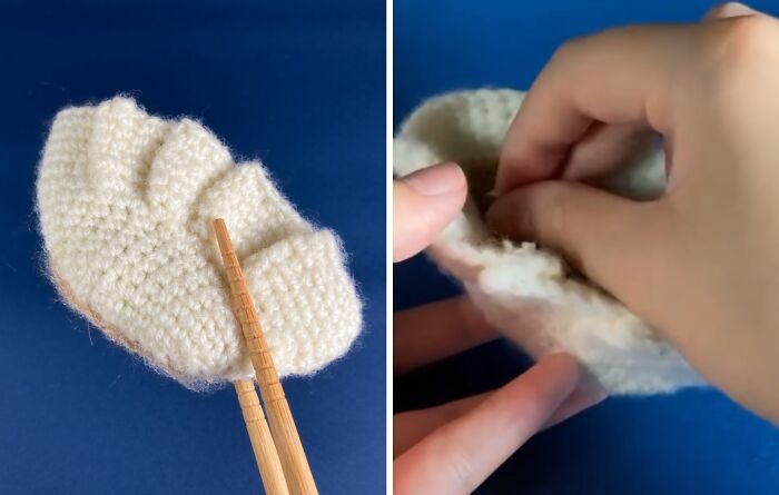 Crocheted realistic dumpling accessory inspired by Japanese fiber art held with chopsticks against a blue background.