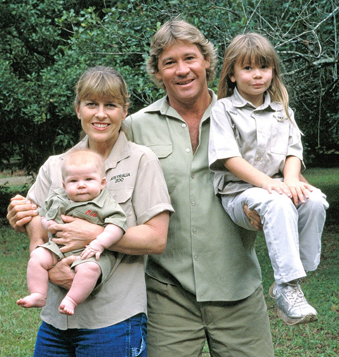 Bindi Irwin as a child with her family in Australia Zoo uniforms, highlighting the decision to leave Australia. Bindi Irwin as a child with her family in Australia Zoo uniforms, highlighting the decision to leave Australia.