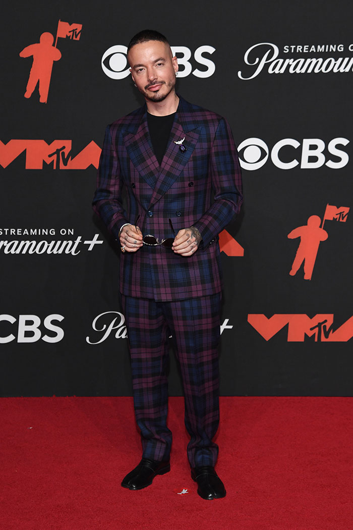 Male celebrity wearing a plaid suit posing on the red carpet showcasing stunning celebrity looks at 2025 MTV Video Music Awards.