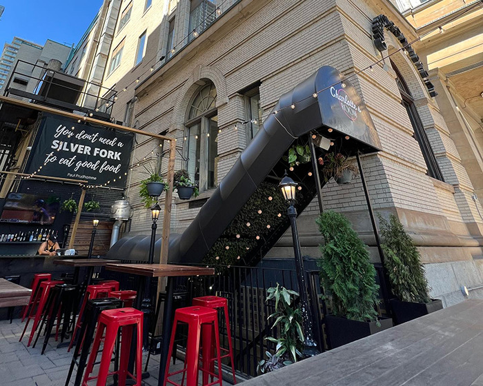 Outdoor bar area with red stools and plants, setting scene related to James McAvoy sucker punched incident.